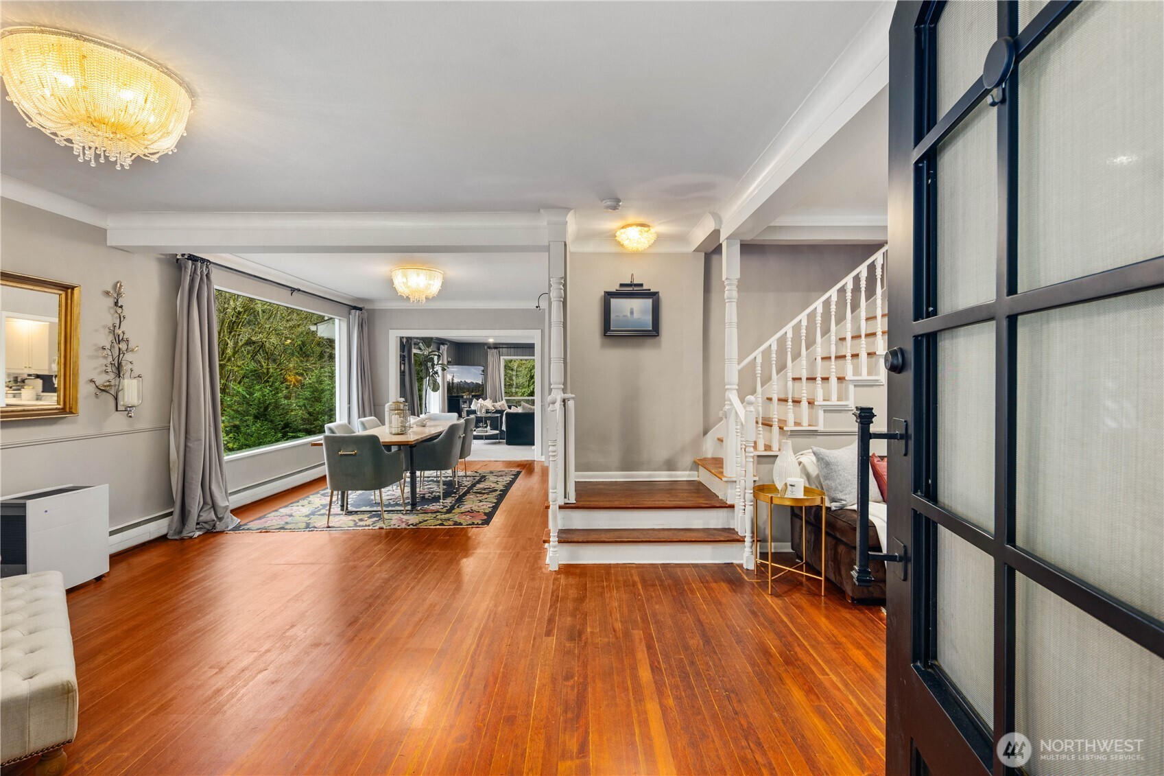 641 Northwest 175th Street Shoreline, WA 98177 - Photo 4 of 40 a view of a living room with furniture floor to ceiling window and wooden floor