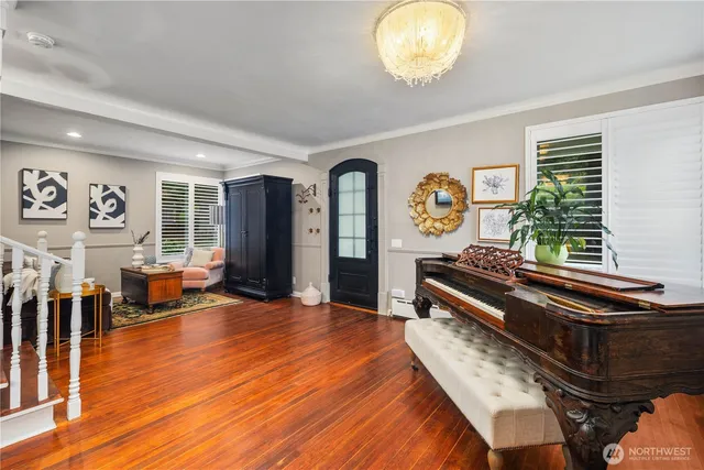 a living room with furniture and wooden floor