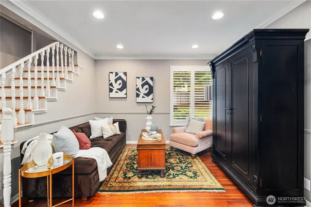 a living room with furniture and wooden floor