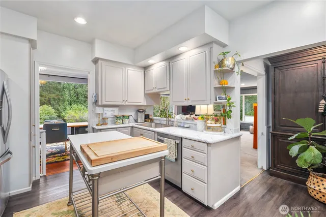 a kitchen with a stove a refrigerator and a sink