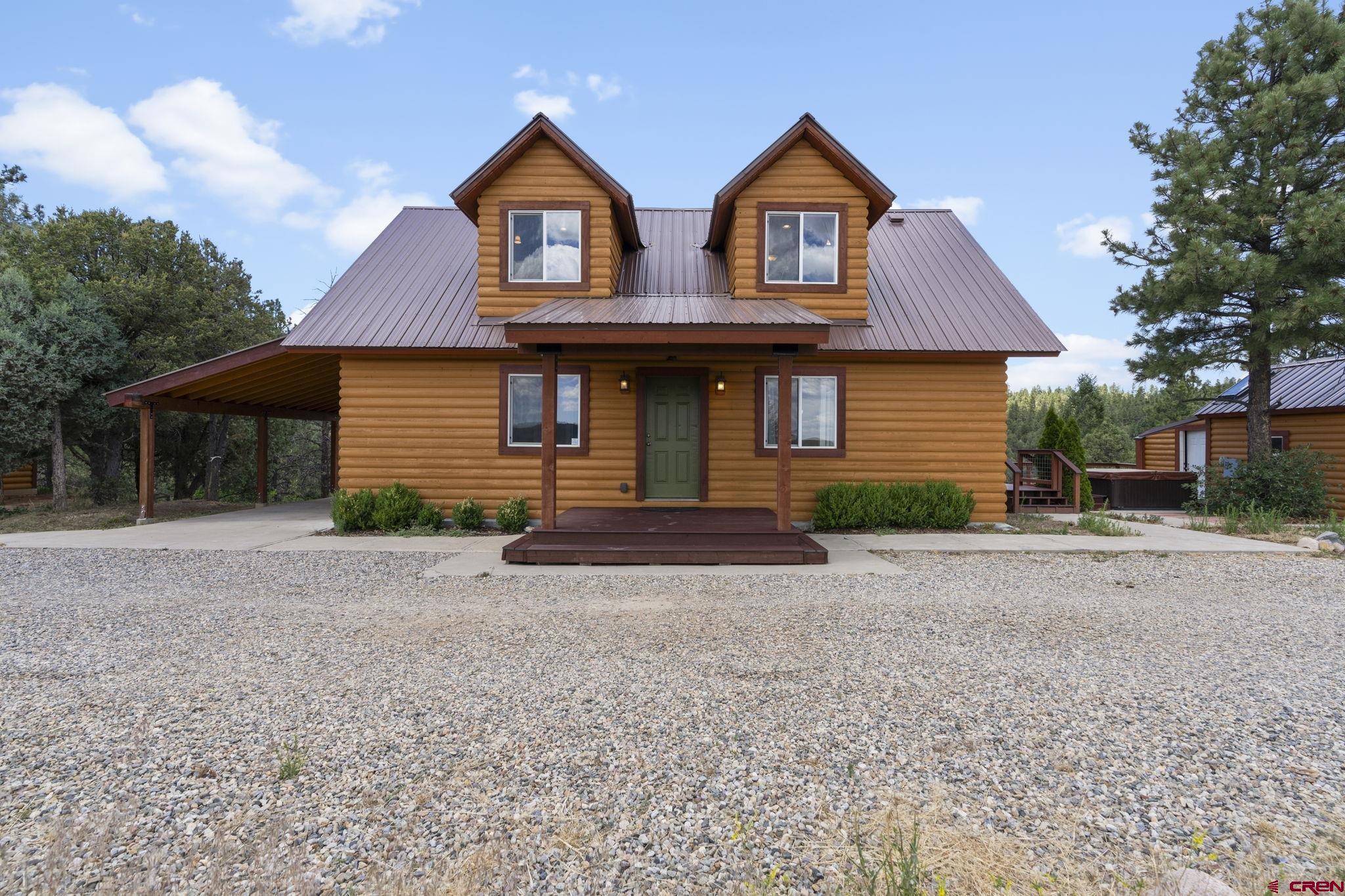 447 Mountain Top Road Durango, CO 81303 - Photo 1 of 33 a front view of a house with yard and trees