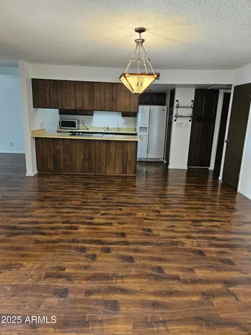 a view of a kitchen with wooden floor