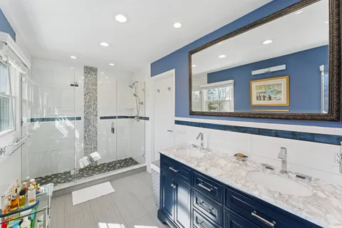 a bathroom with a granite countertop sink mirror and double