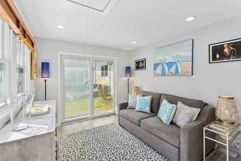 a living room with furniture and a glass door
