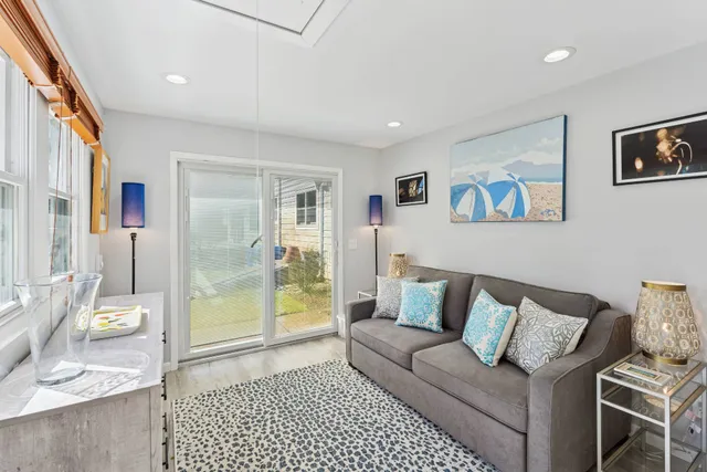 a living room with furniture and a glass door
