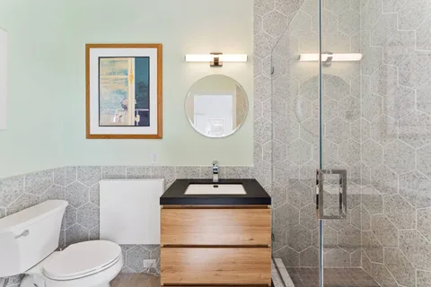 a bathroom with a sink toilet and shower