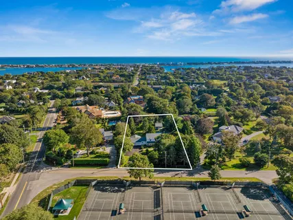 an aerial view of multiple houses with a swimming pool
