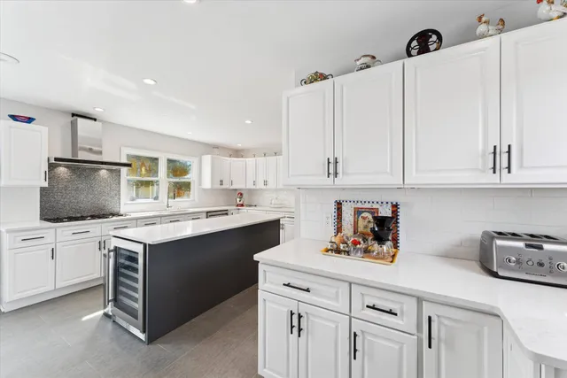 a kitchen with white cabinets sink and white appliances