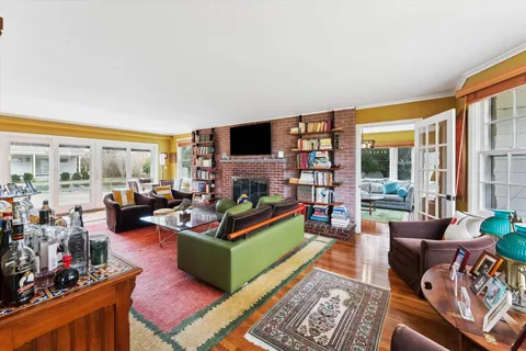 a living room with furniture large window and a flat screen tv