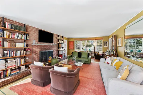 a living room with fireplace furniture and a flat screen tv