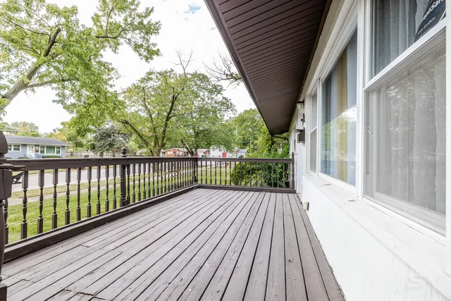 a view of a balcony with wooden floor