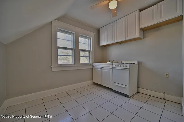 a utility room with cabinets washer and dryer