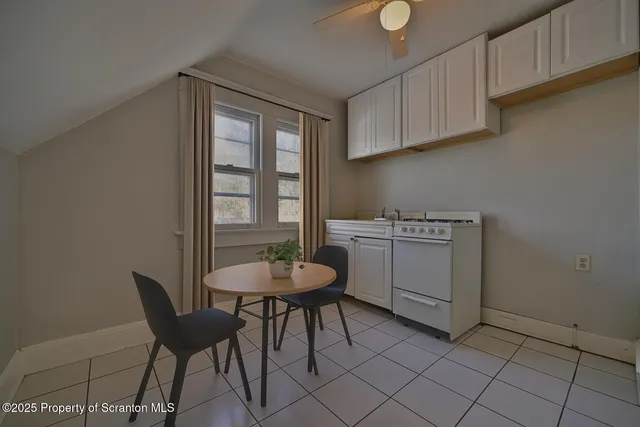 a view of a kitchen with a dining table and chairs