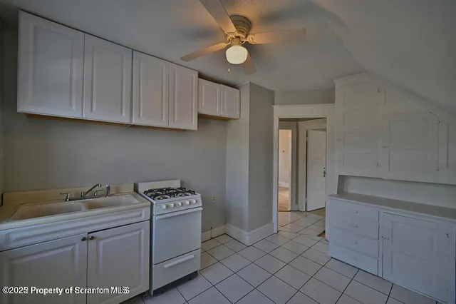 a kitchen with a sink cabinets and appliances
