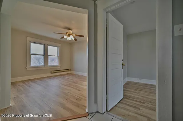 a view of an empty room with a window