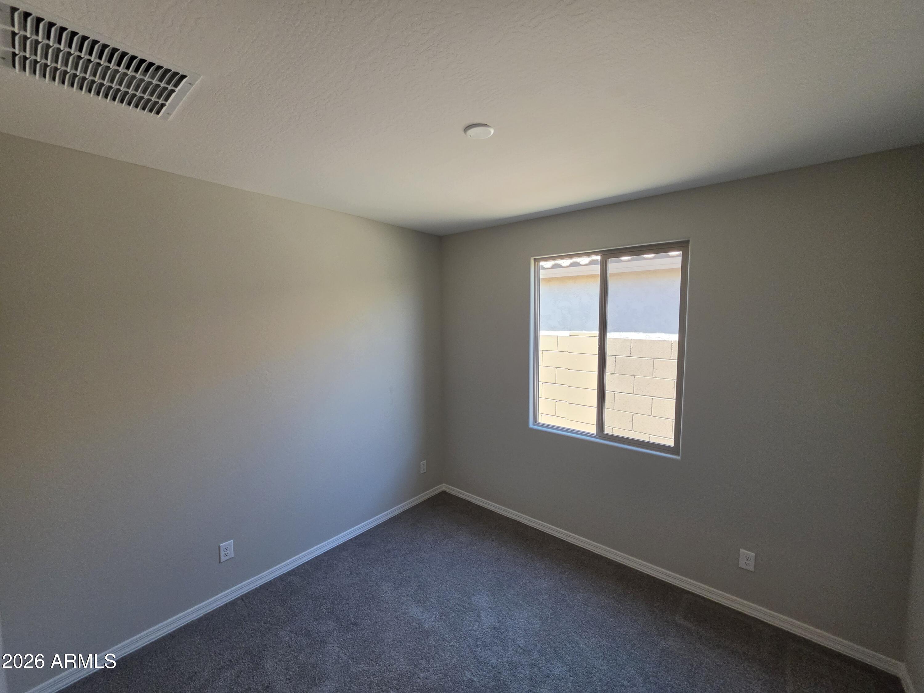 7128 West Coles Road Laveen, AZ 85339 - Photo 27 of 38 an empty room with a window