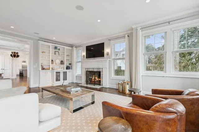 a living room with furniture a fireplace and a flat screen tv