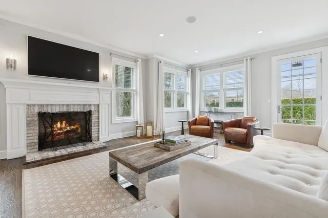 a living room with furniture flat screen tv and a fireplace