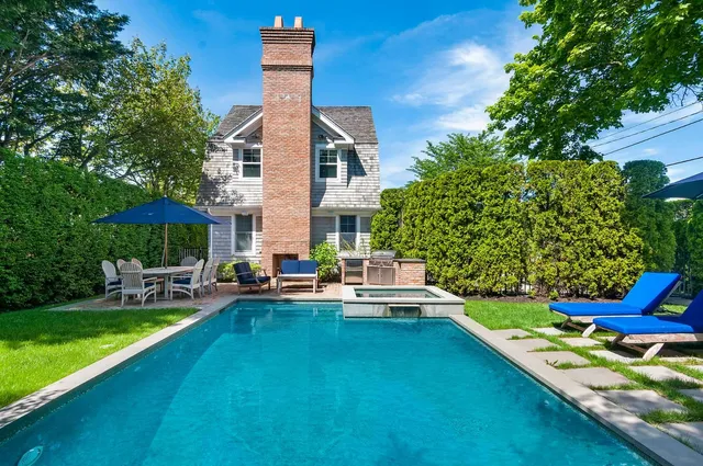 a view of a house with a yard patio and sitting area