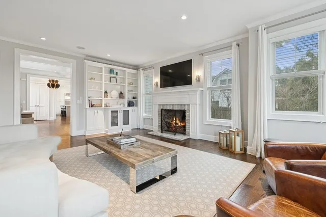 a view of a hallway with wooden floor and dining room
