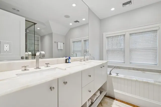 a spacious bedroom with a bed and a chandelier