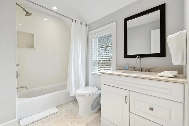 a spacious bathroom with a toilet sink and shower