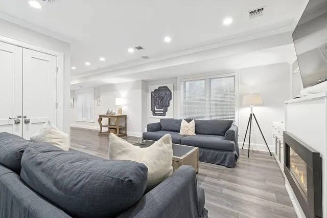 a view of entryway with wooden floor and dining room