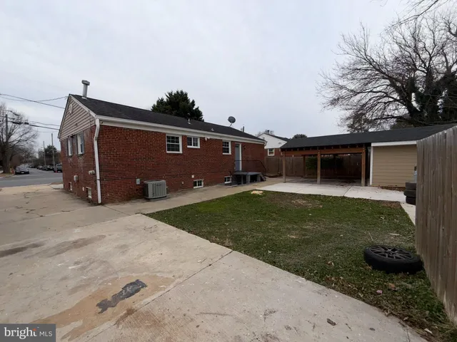 a view of a backyard with plants and a fence