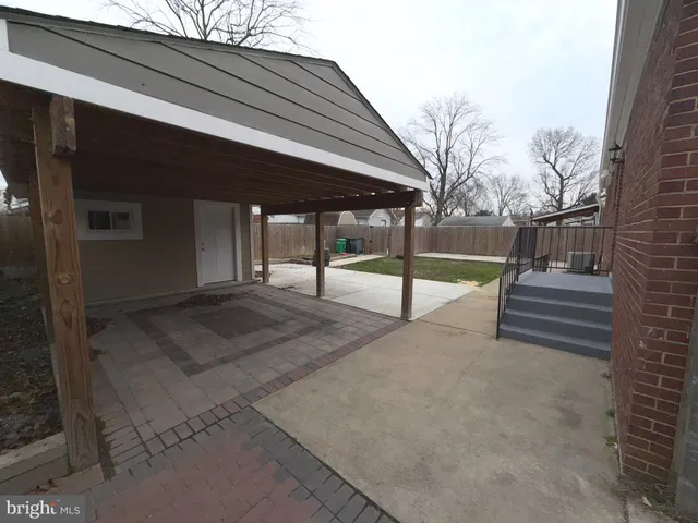 a view of backyard with wooden fence