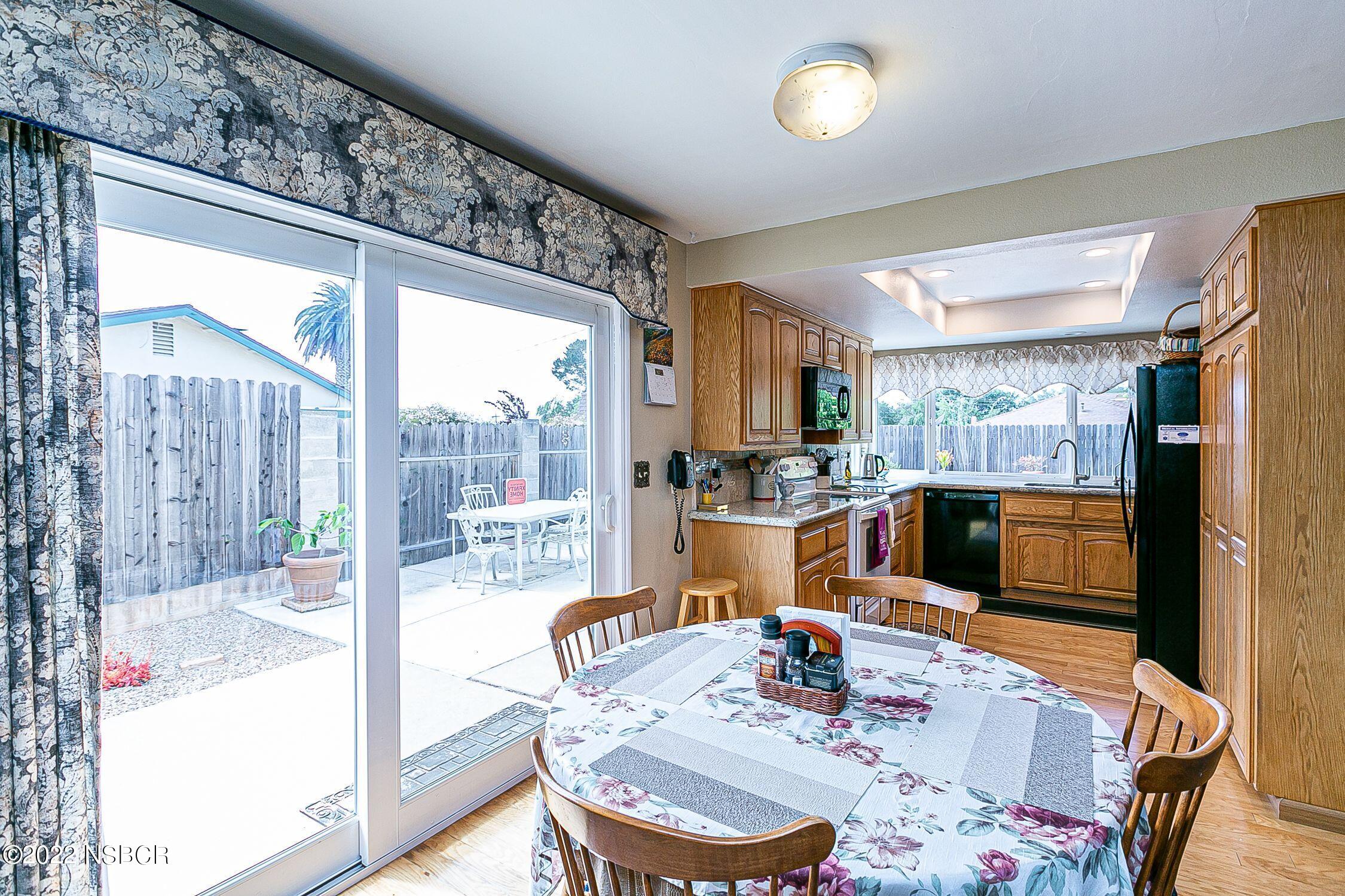 4212 Centaur Avenue Lompoc, CA 93436 - Photo 12 of 30 a dining room with furniture a chandelier and wooden floor