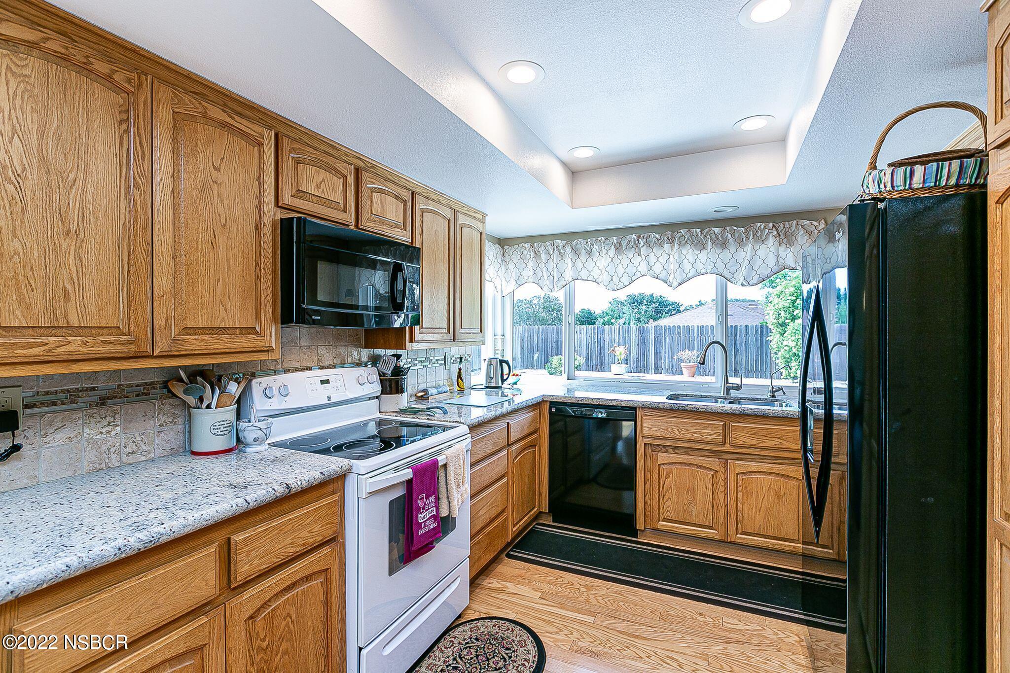 4212 Centaur Avenue Lompoc, CA 93436 - Photo 13 of 30 a kitchen with granite countertop a sink stove and cabinets