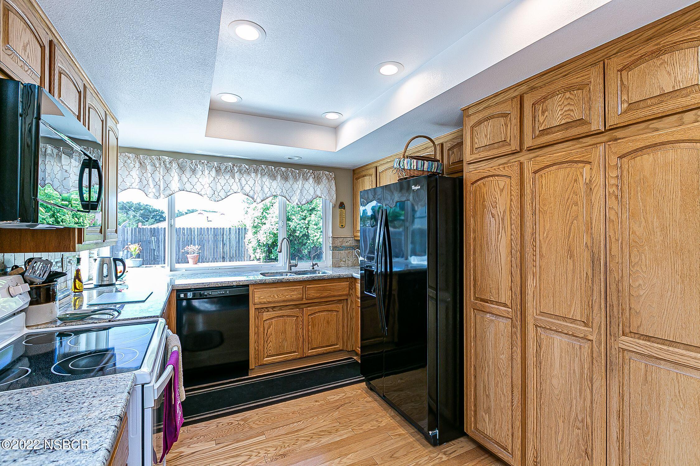 4212 Centaur Avenue Lompoc, CA 93436 - Photo 14 of 30 a kitchen with stainless steel appliances granite countertop a refrigerator and a stove