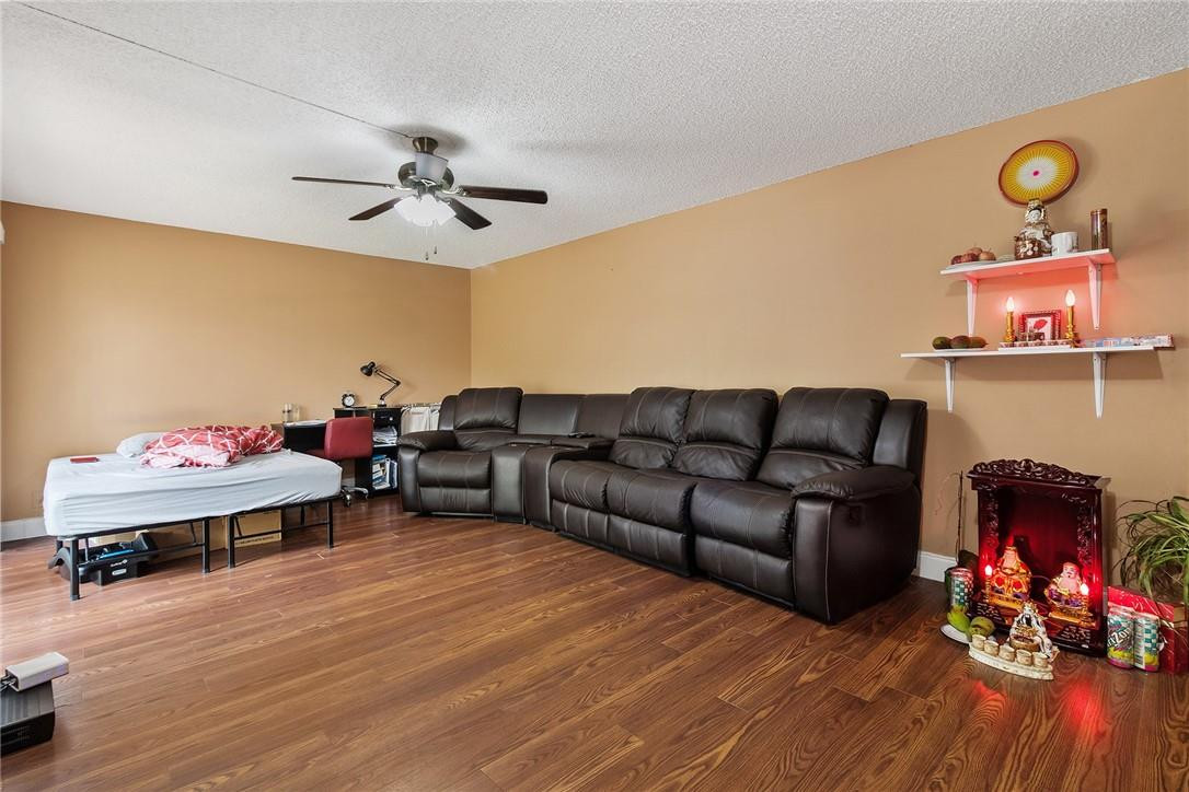 7543 Courtyard Run East, Unit 7543 Boca Raton, FL 33433 - Photo 2 of 15 a living room with furniture and wooden floor