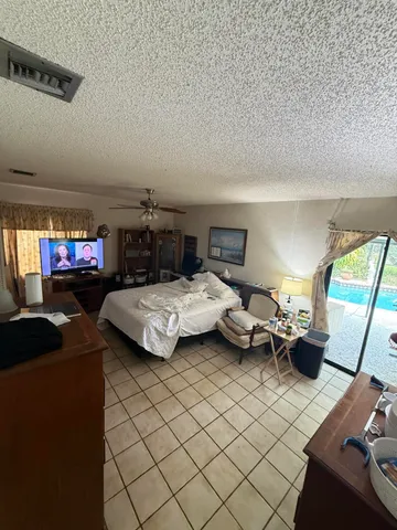 a bedroom with furniture parked on the wall and a window