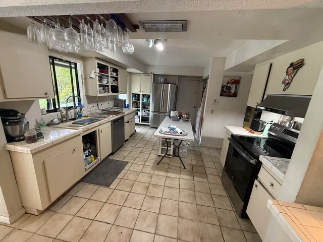 a kitchen with a sink appliances and cabinets