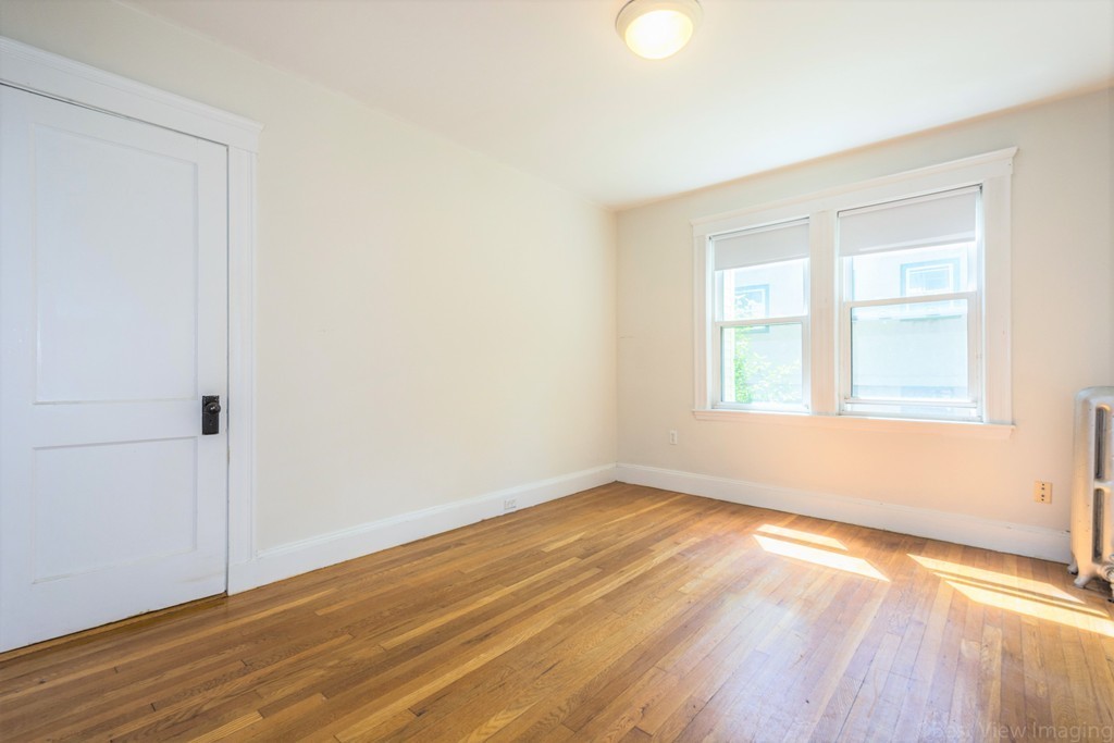 59-61 Brington Road Brookline, MA 02445 - Photo 15 of 19 an empty room with wooden floor and windows
