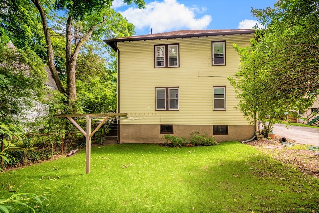 59-61 Brington Road Brookline, MA 02445 - Photo 18 of 19 a view of a house with a yard and sitting area