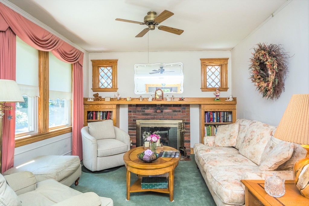 59-61 Brington Road Brookline, MA 02445 - Photo 4 of 19 a living room with furniture a window and a fireplace