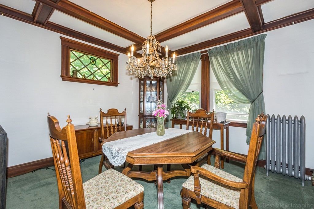 59-61 Brington Road Brookline, MA 02445 - Photo 6 of 19 a dining room with furniture a rug and a chandelier