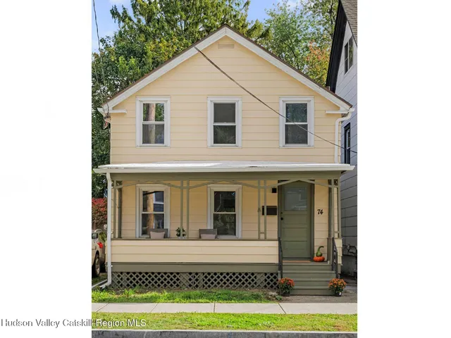 a view of a white house with large windows