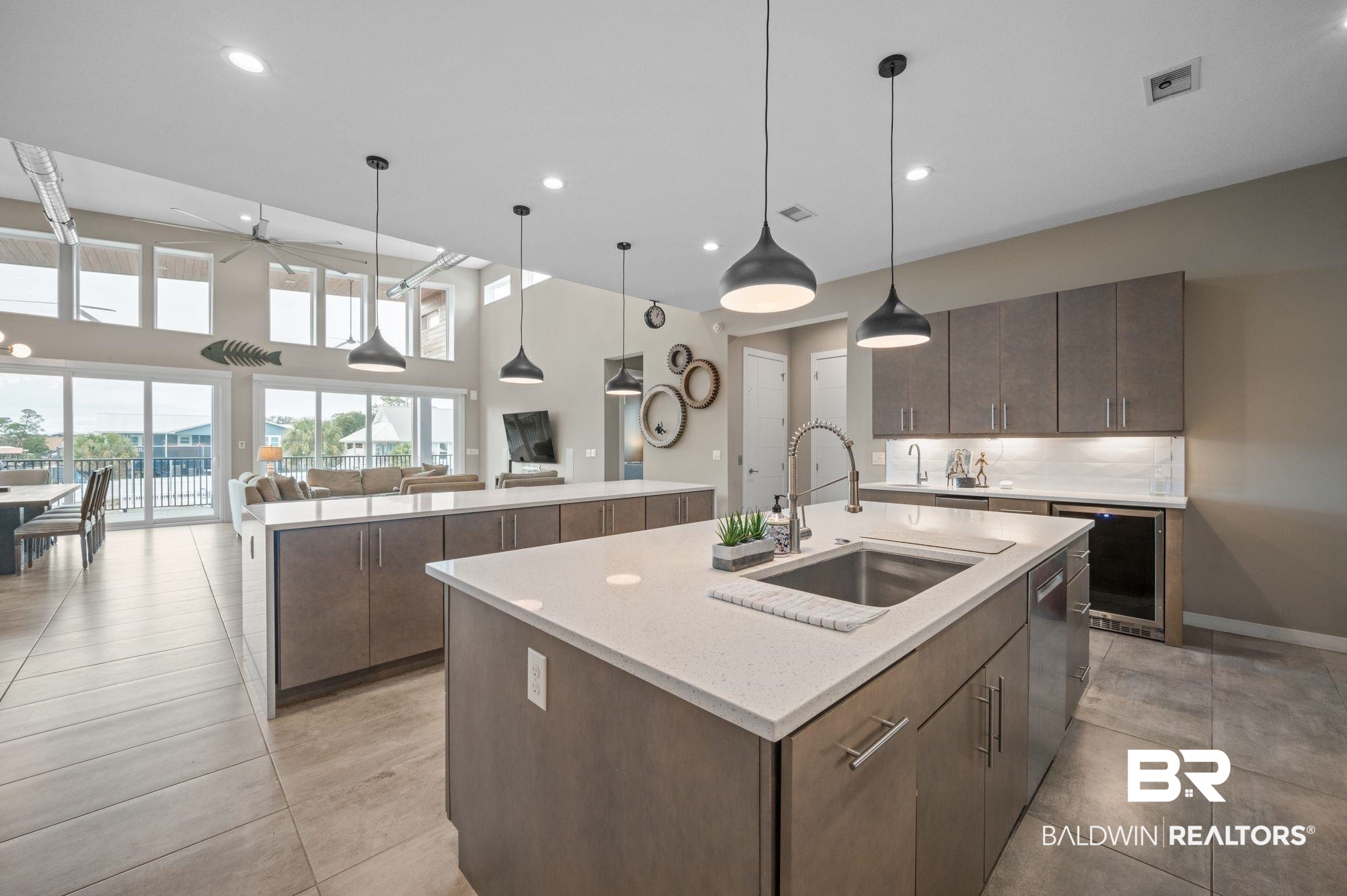 3840 Cotton Way Orange Beach, AL 36561 - Photo 17 of 75 Kitchen featuring dishwasher, a center island with sink, hanging light fixtures, and sink