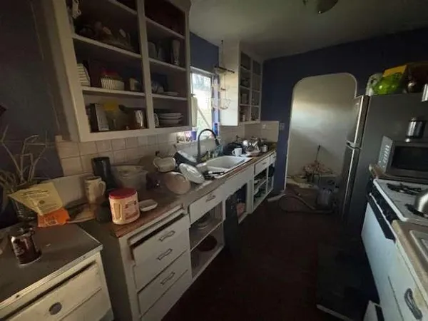a kitchen with stove and cabinets