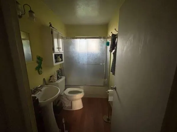 a bathroom with a sink toilet and shower