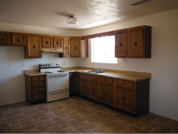 2125 W Road Chino Valley, AZ 86323 - Photo 3 of 20 a kitchen with stainless steel appliances granite countertop a sink cabinets and a window