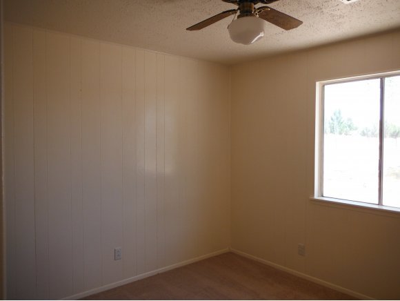 2125 W Road Chino Valley, AZ 86323 - Photo 7 of 20 an empty room with a window and a fan