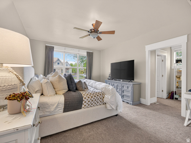 557 Craftsman Way Midway, UT 84049 - Photo 23 of 59 Carpeted room featuring a ceiling fan with light fixture, a wide window with exterior views, and a doorway with white trim