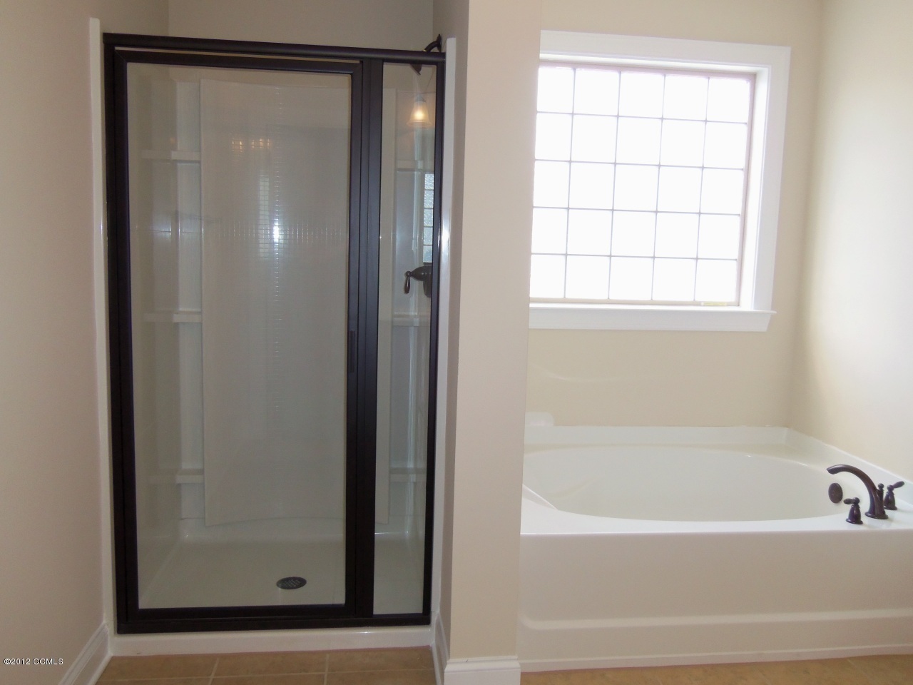 103 Summer Rst Trail Hubert, NC 28539 - Photo 11 of 13 Separate tub and shower in master bath. Tile floors, oil rubbed bronze fixtures and lighting.