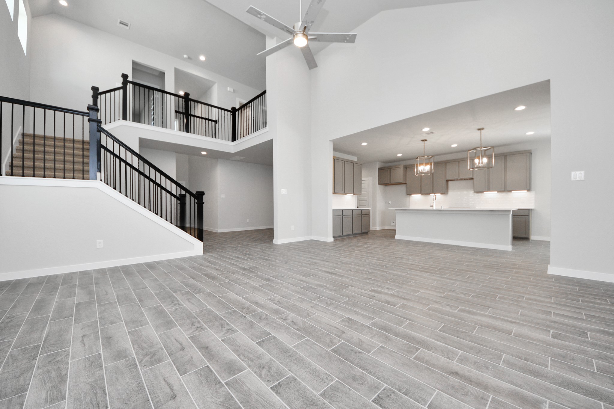 3002 Bury Park Dr Spring Spring, TX 77373 - Photo 12 of 45 Family room flooded with natural light through the expansive windows. The premium tile flooring adds a touch of luxury to the space, creating the perfect setting for relaxing moments and cherished gatherings with loved ones.