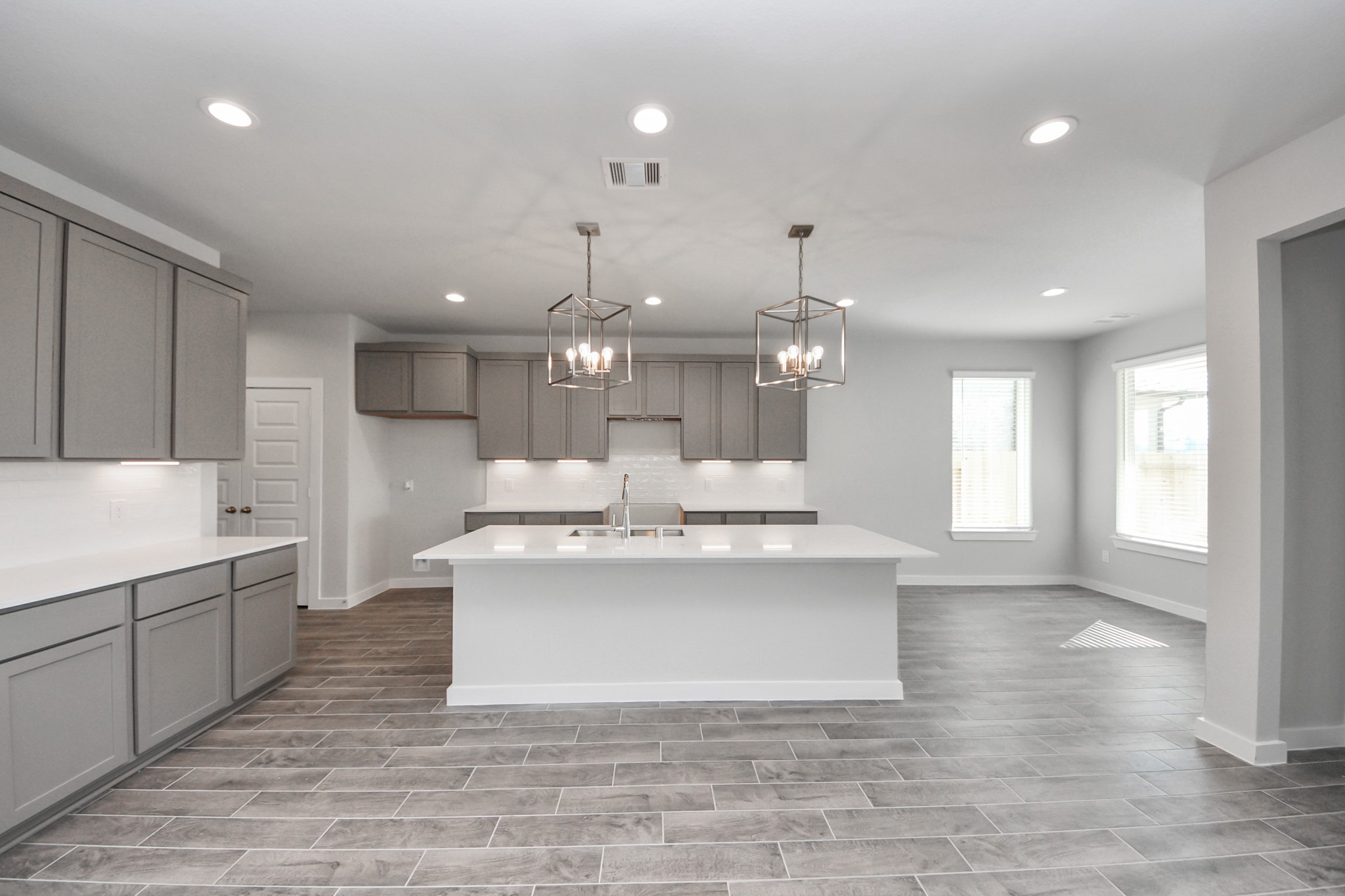 3002 Bury Park Dr Spring Spring, TX 77373 - Photo 15 of 45 This kitchen is by far any chef’s dream! This spacious kitchen features high ceilings, light stained wood cabinets, granite countertop, SS appliances, modern tile backsplash, recessed lighting, extended counter space, granite kitchen island with double sink, and space for breakfast bar, and a walk-in pantry all overlooking your huge family room.