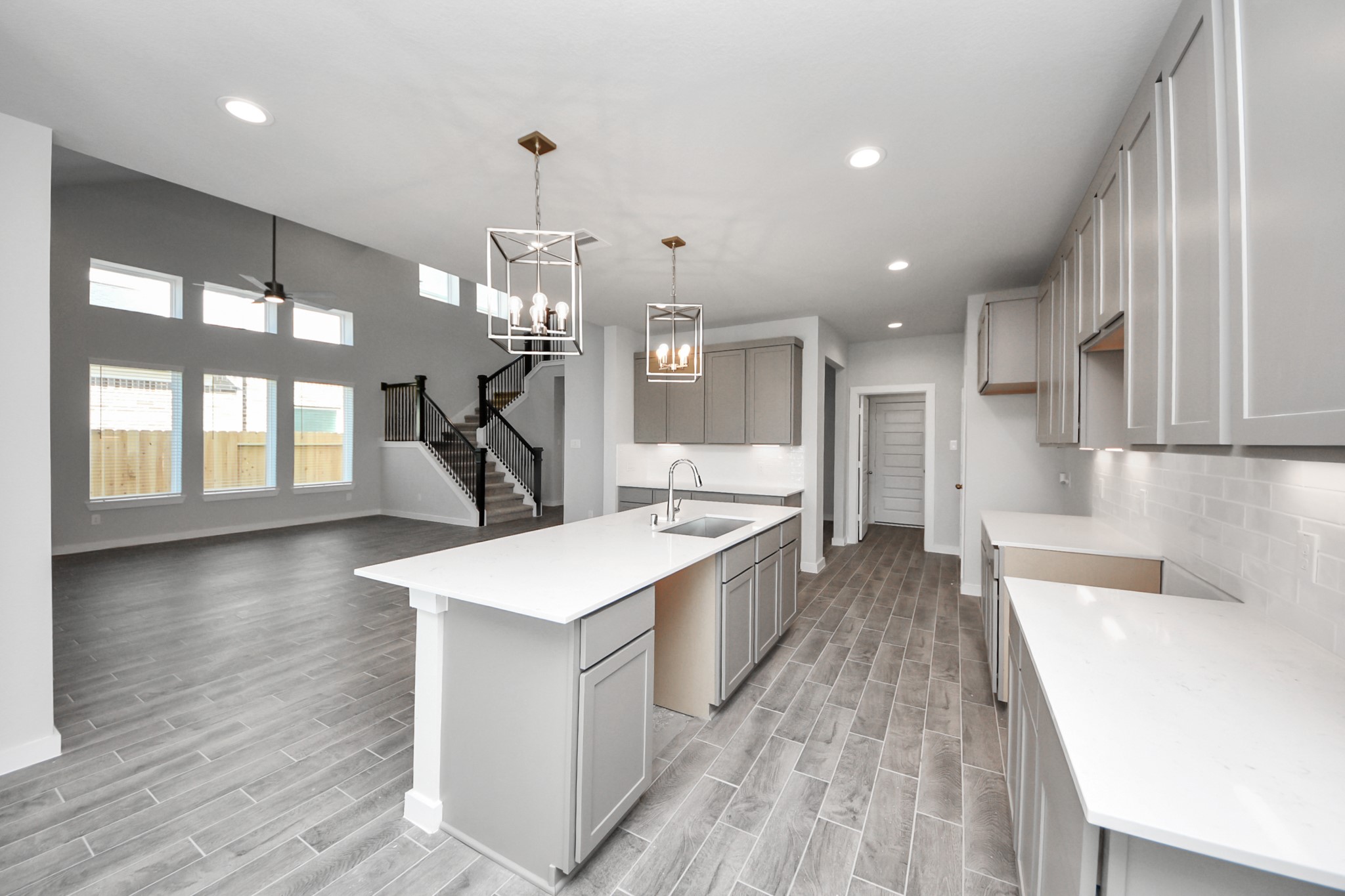 3002 Bury Park Dr Spring Spring, TX 77373 - Photo 16 of 45 a large kitchen with kitchen island a stove a sink a refrigerator and a dining table with wooden floor